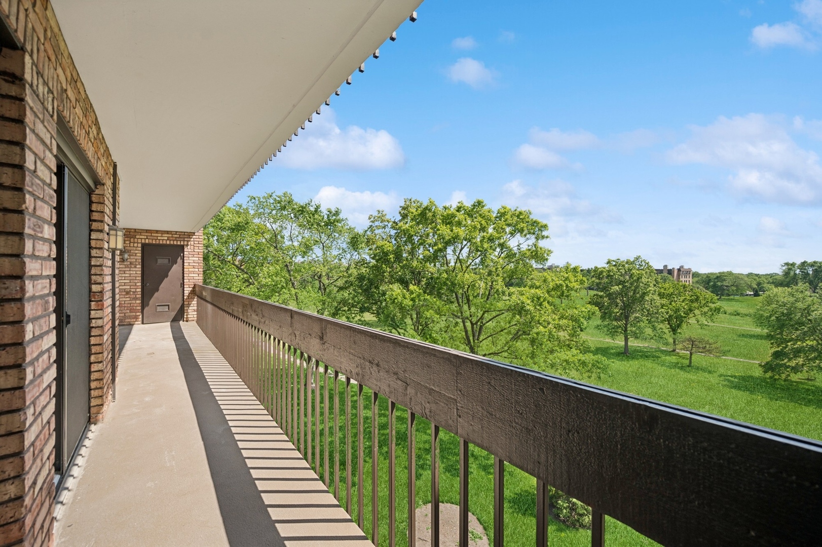 3851 Mission Hills Road, Unit 409 Northbrook, IL 60062 - Photo 16 of 19 a view of a balcony with wooden floor and fence