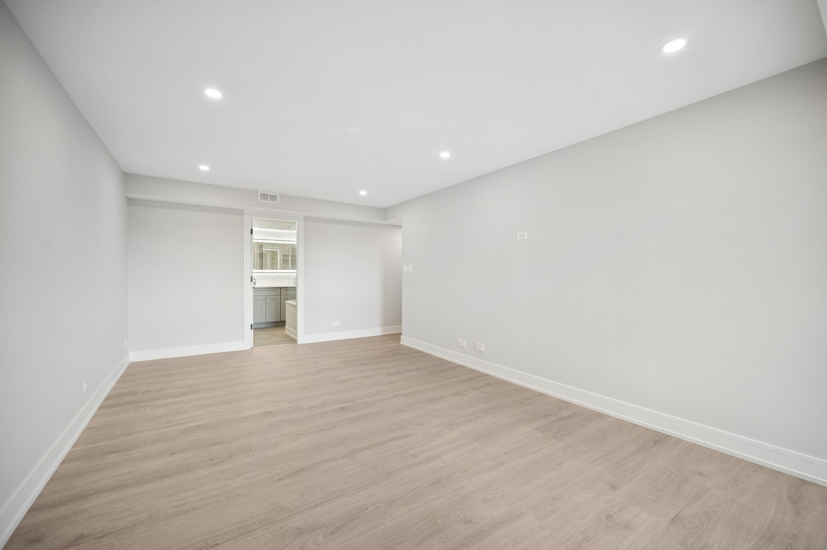 3851 Mission Hills Road, Unit 409 Northbrook, IL 60062 - Photo 9 of 19 an empty room with wooden floor and windows