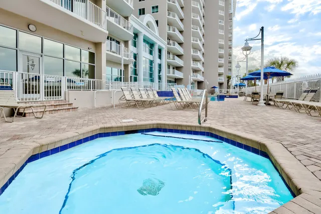 a swimming pool with outdoor seating and windows