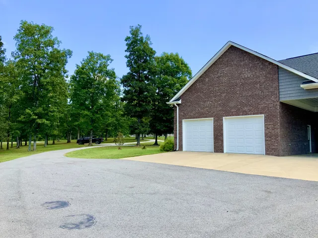 a view of backyard of house with green space