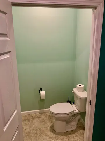 a spacious bathroom with a granite countertop sink and a mirror