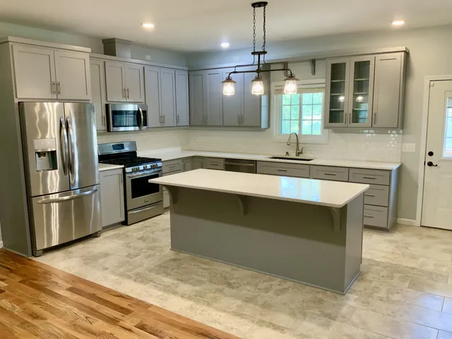 a view of a hallway with wooden floor and closet