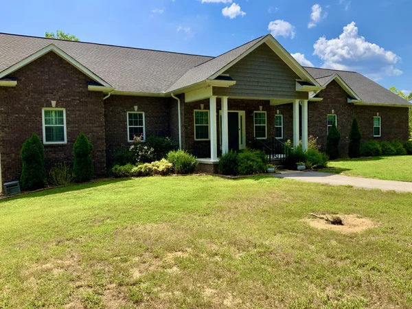 a view of a house with a yard and garage