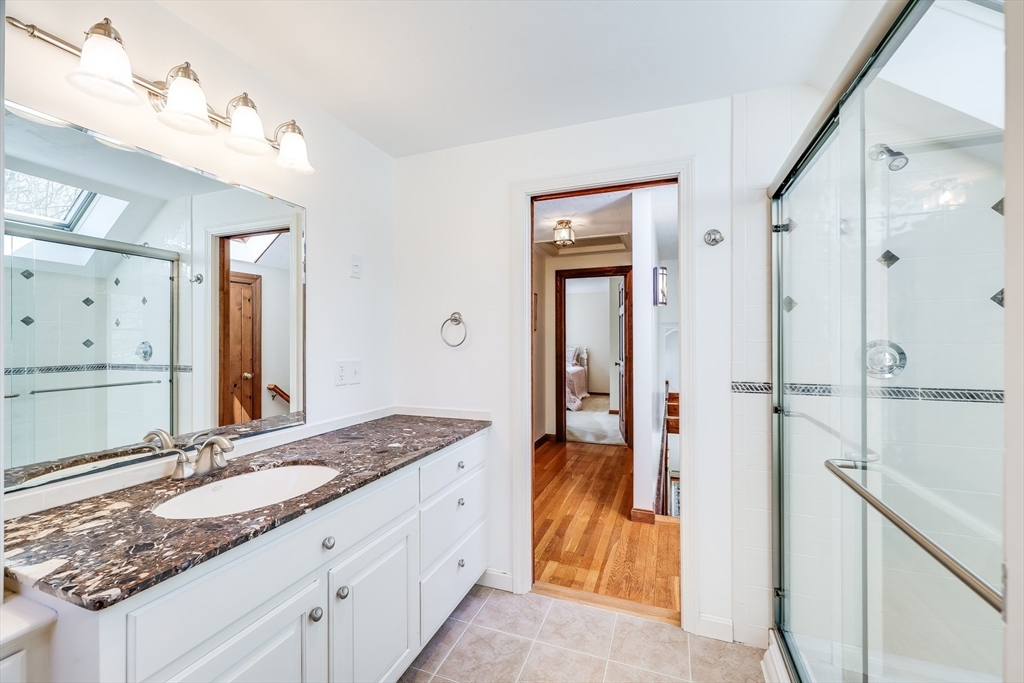 59 Valley Road Brewster, MA 02631 - Photo 24 of 42 a en suite bathroom with a granite countertop sink and a mirror