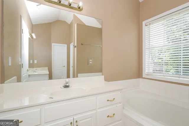 a bathroom with a bathtub and a sink