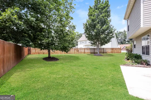 a view of a house with a backyard