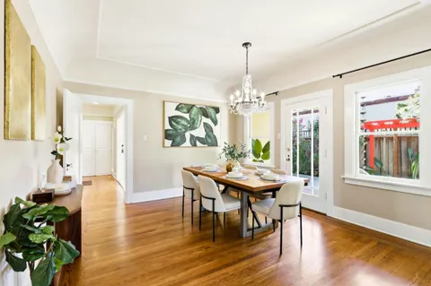 a view of a dining room with furniture window and wooden floor