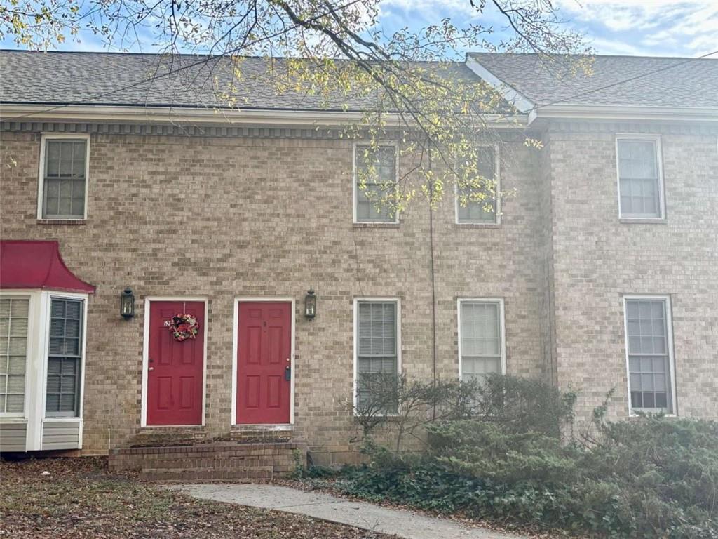 5296 Weyden Trail, Unit B Norcross, GA 30071 - Photo 1 of 25 a front view of a house with large windows