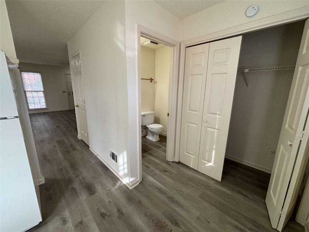 5296 Weyden Trail, Unit B Norcross, GA 30071 - Photo 14 of 25 a view of a hallway with wooden floor and a bathroom