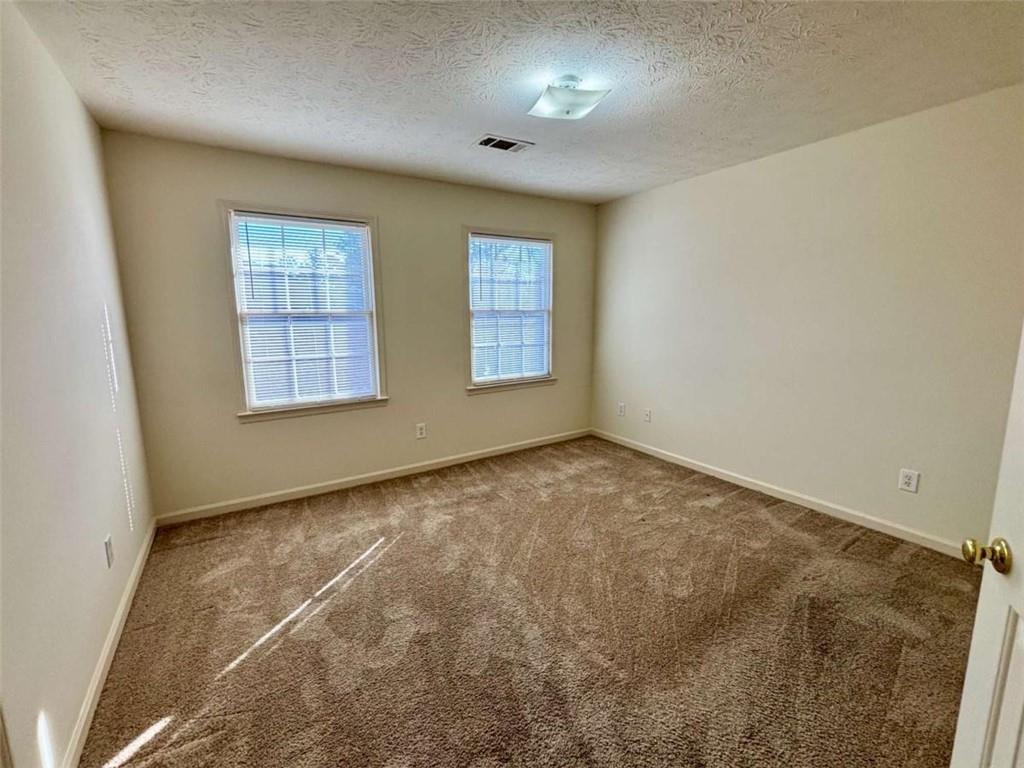5296 Weyden Trail, Unit B Norcross, GA 30071 - Photo 15 of 25 an empty room with windows