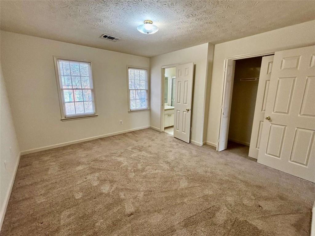 5296 Weyden Trail, Unit B Norcross, GA 30071 - Photo 18 of 25 an empty room with windows
