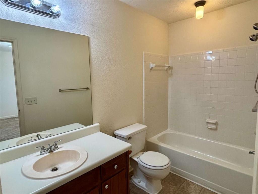 5296 Weyden Trail, Unit B Norcross, GA 30071 - Photo 21 of 25 a bathroom with a sink a toilet a mirror a bathtub and shower