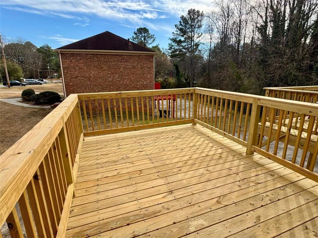 5296 Weyden Trail, Unit B Norcross, GA 30071 - Photo 23 of 25 a view of balcony with wooden floor and fence and trees