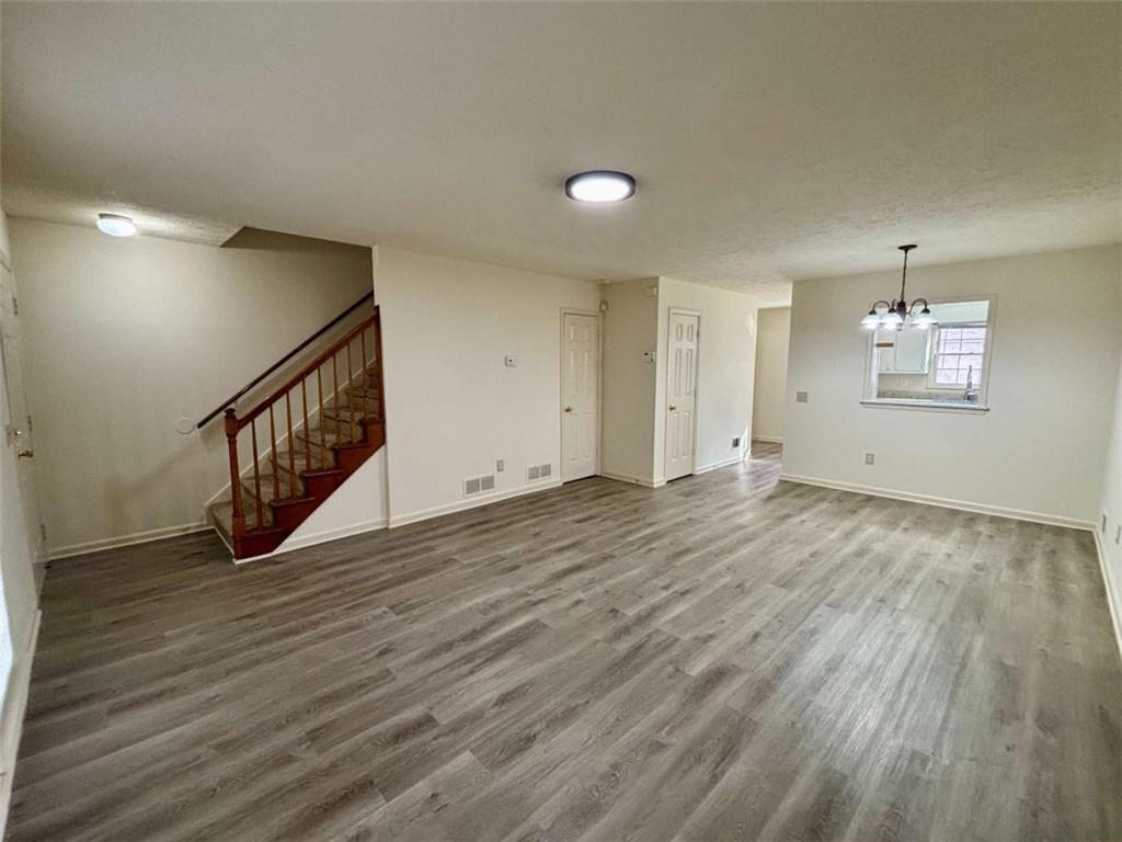5296 Weyden Trail, Unit B Norcross, GA 30071 - Photo 3 of 22 an empty room with wooden floor and windows