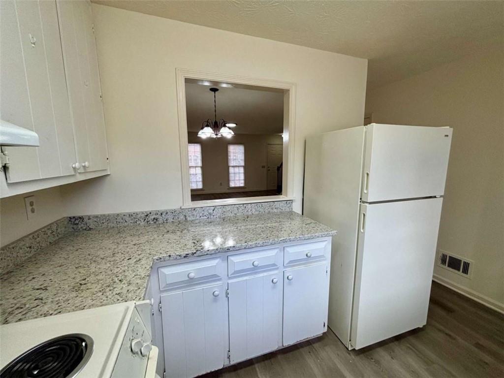 5296 Weyden Trail, Unit B Norcross, GA 30071 - Photo 9 of 25 a kitchen with a refrigerator and a sink