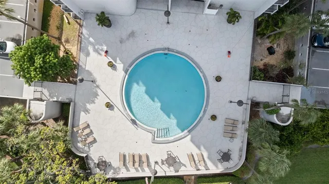 an aerial view of a house with garden space and swimming pool