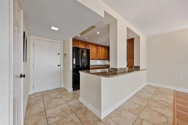a kitchen with stainless steel appliances granite countertop a refrigerator and a sink