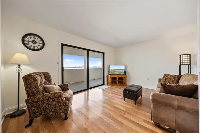 a living room with furniture a couch and a flat screen tv
