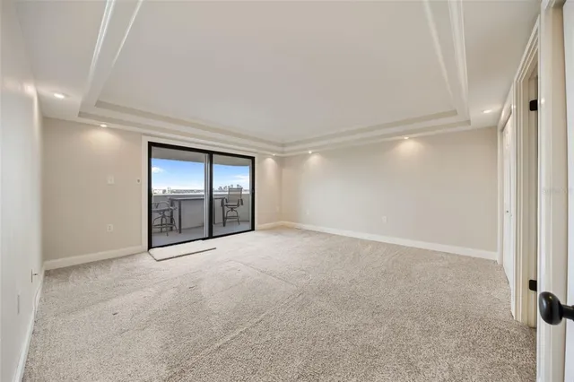 a view of an empty room with window and bathroom