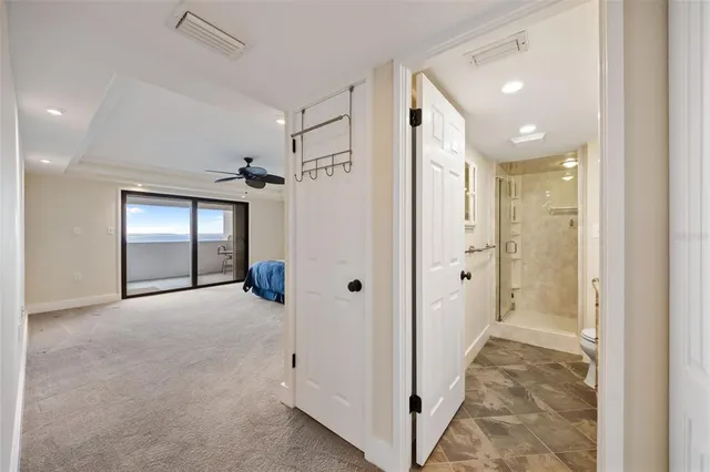 a bathroom with a granite countertop sink a toilet a mirror and shower