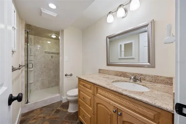 a spacious bedroom with a bed and a chandelier