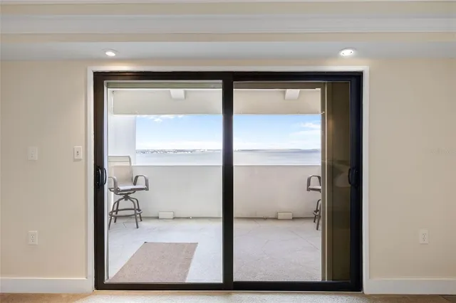 a room with a chair and potted plant