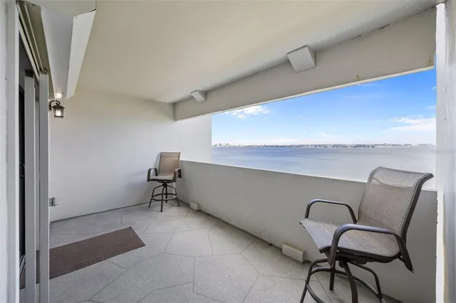 a view of a chairs and table in a balcony