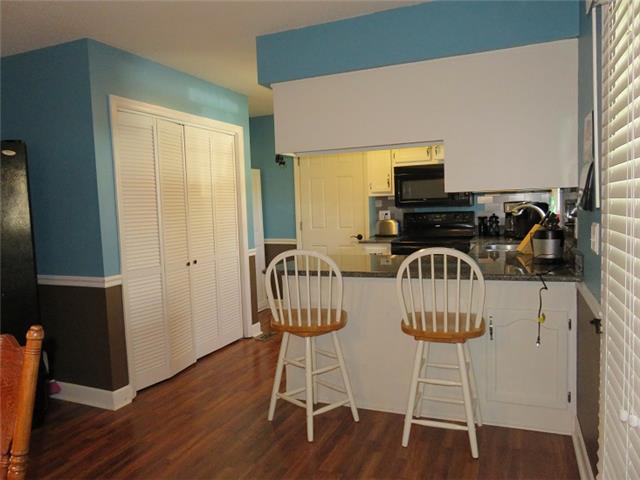 954 Riley Creek Road Tullahoma, TN 37388 - Photo 4 of 16 Kitchen with granite countertops, microwave, DW, stove, eat in bar, and refrigerator