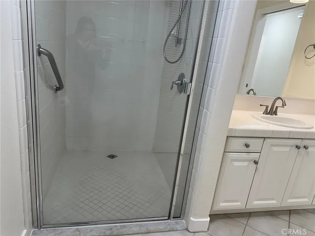a bathroom with a shower and a sink