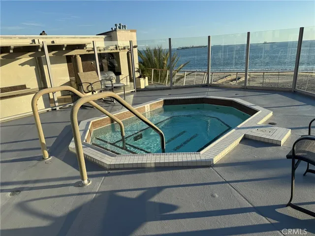 a view of a swimming pool with outdoor seating