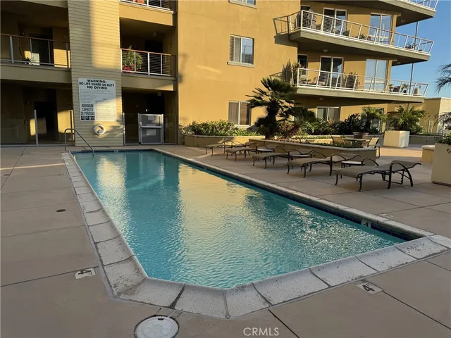 a view of a swimming pool with outdoor seating