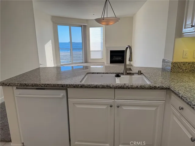 a kitchen with granite countertop cabinets and window