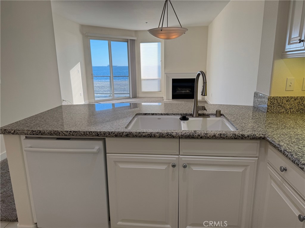 1400 East Ocean Boulevard, Unit 1203 Long Beach, CA 90802 - Photo 7 of 34 a kitchen with granite countertop cabinets and window