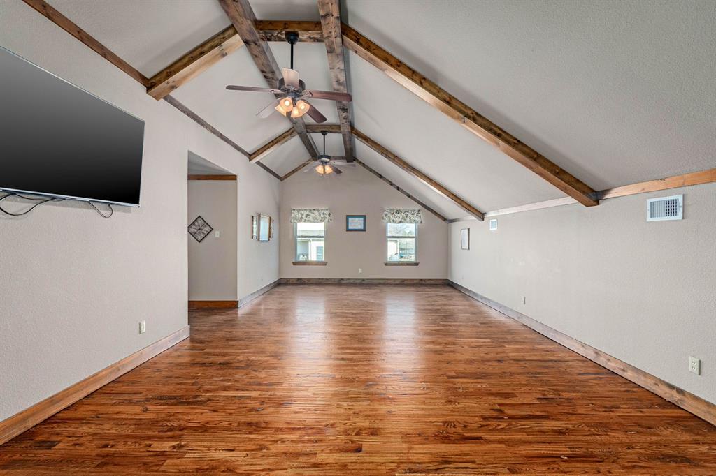 3028 Harrell Road Howe, TX 75459 - Photo 20 of 39 a view of a livingroom with wooden floor and a ceiling fan