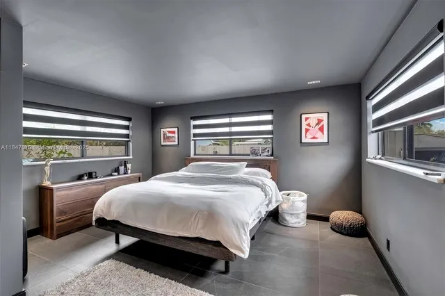 a bedroom with a bed and window