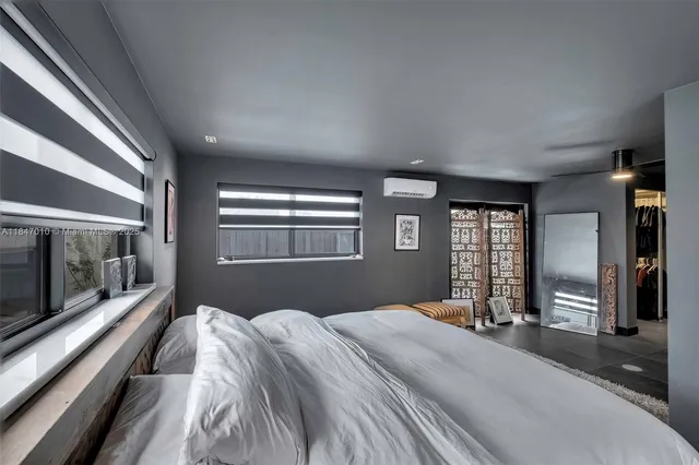 a bedroom with a large bed and a large window