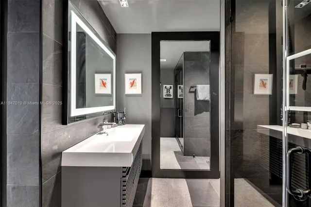a bathroom with a sink a mirror and a shower
