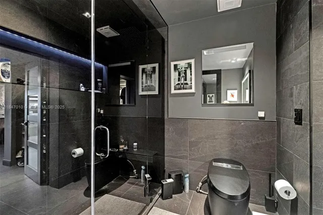 a bathroom with a toilet a sink and shower