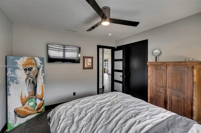 a bedroom with bed and a chandelier