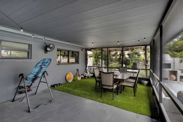a view of a patio with table and chairs potted plants with wooden floor
