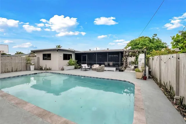 a view of a patio with swimming pool table and chairs