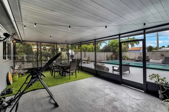 a view of a porch with furniture and garden