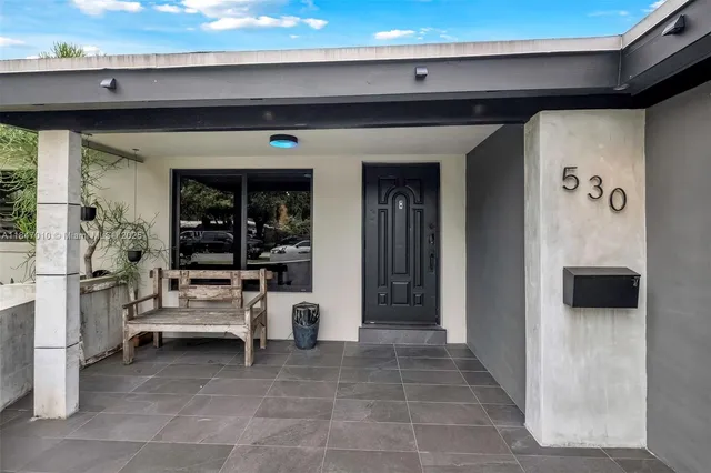 a view of a hallway with entryway and furniture