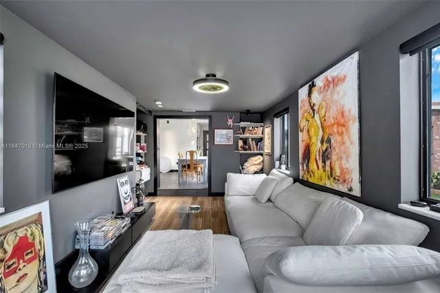a living room with furniture and a flat screen tv