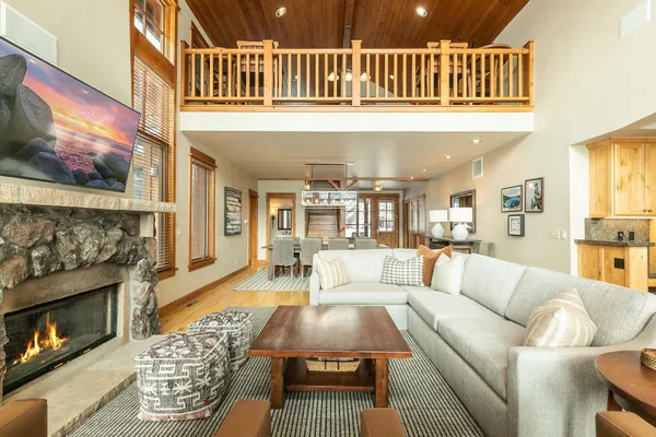 a living room with furniture a fireplace and a flat screen tv