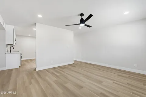a view of a room with wooden floor and white walls