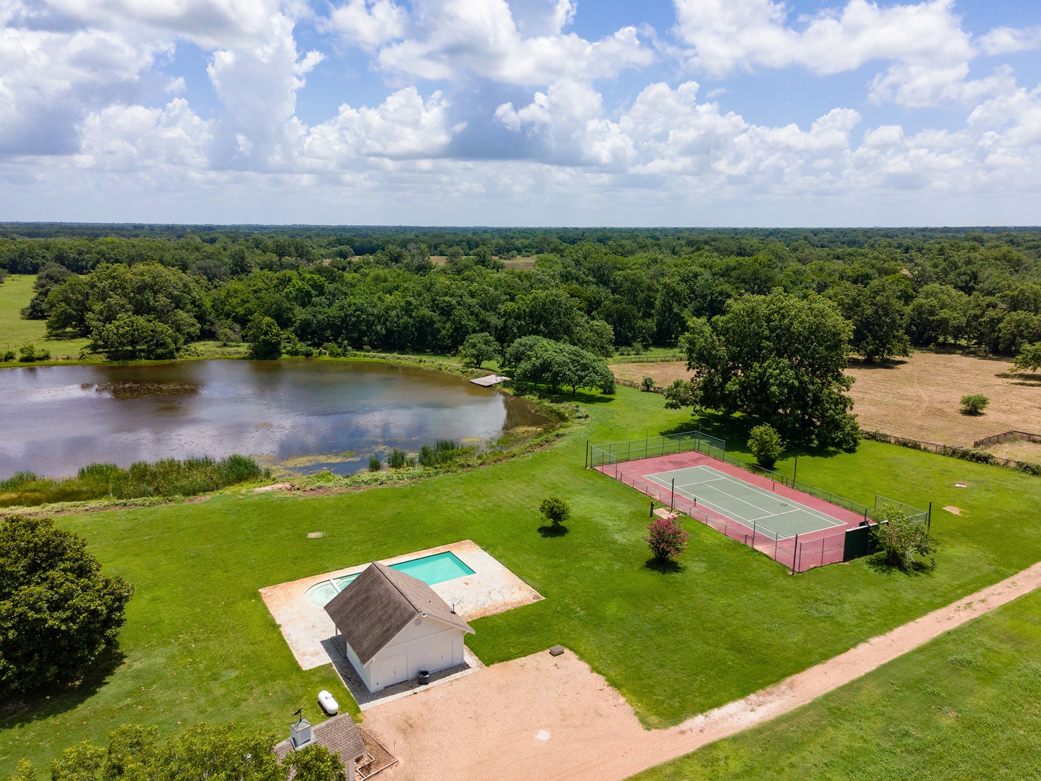 an aerial view of a house with pool big yard and outdoor seating