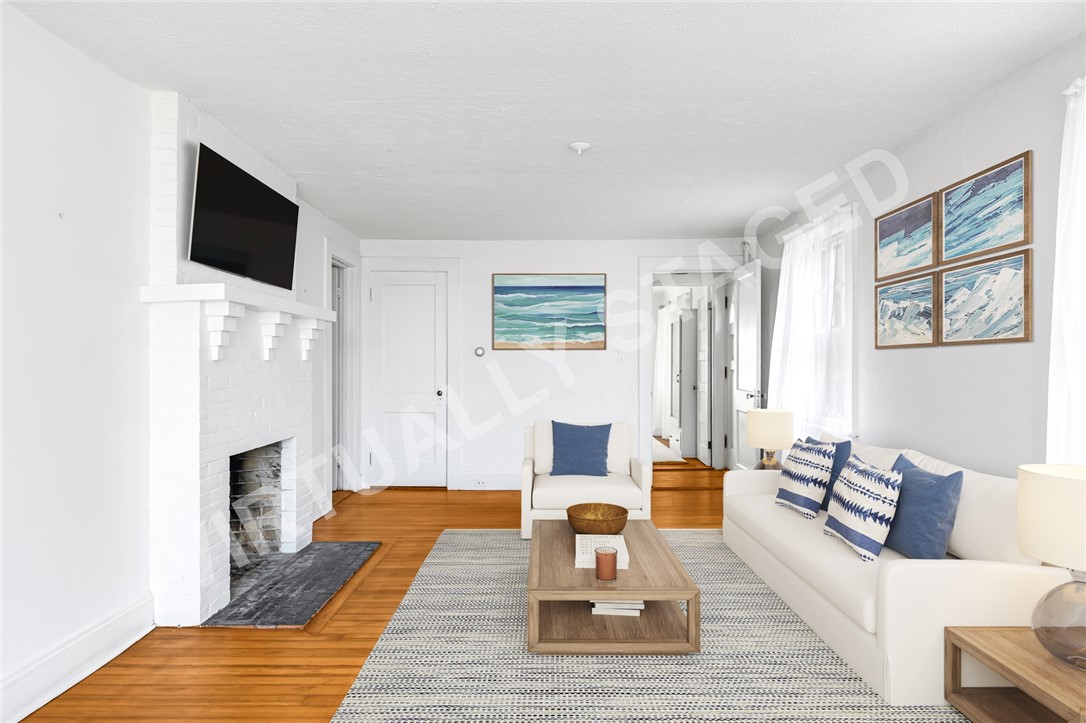 6 Chapel Lane Westerly, RI 02891 - Photo 16 of 46 AI virtual staging. Main house living room features a fireplace