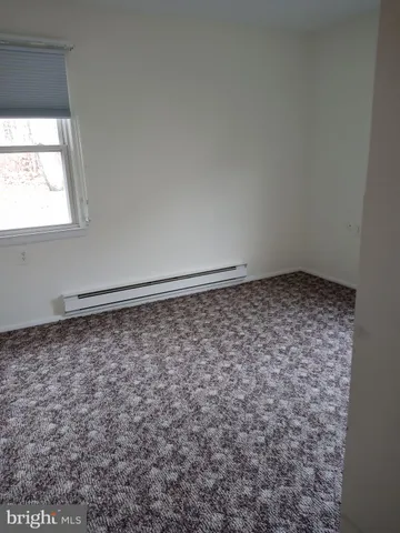 a bathroom with a sink toilet and window