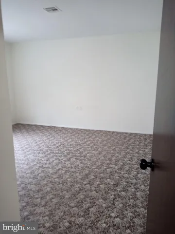 a view of a big room with closet and mirror